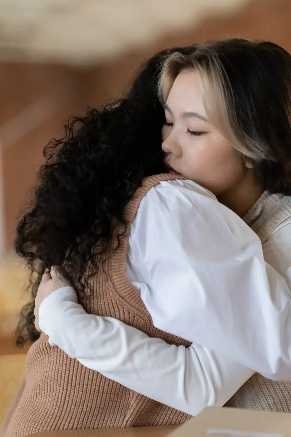 Two women embracing, symbolizing emotional support and connection during addiction treatment.