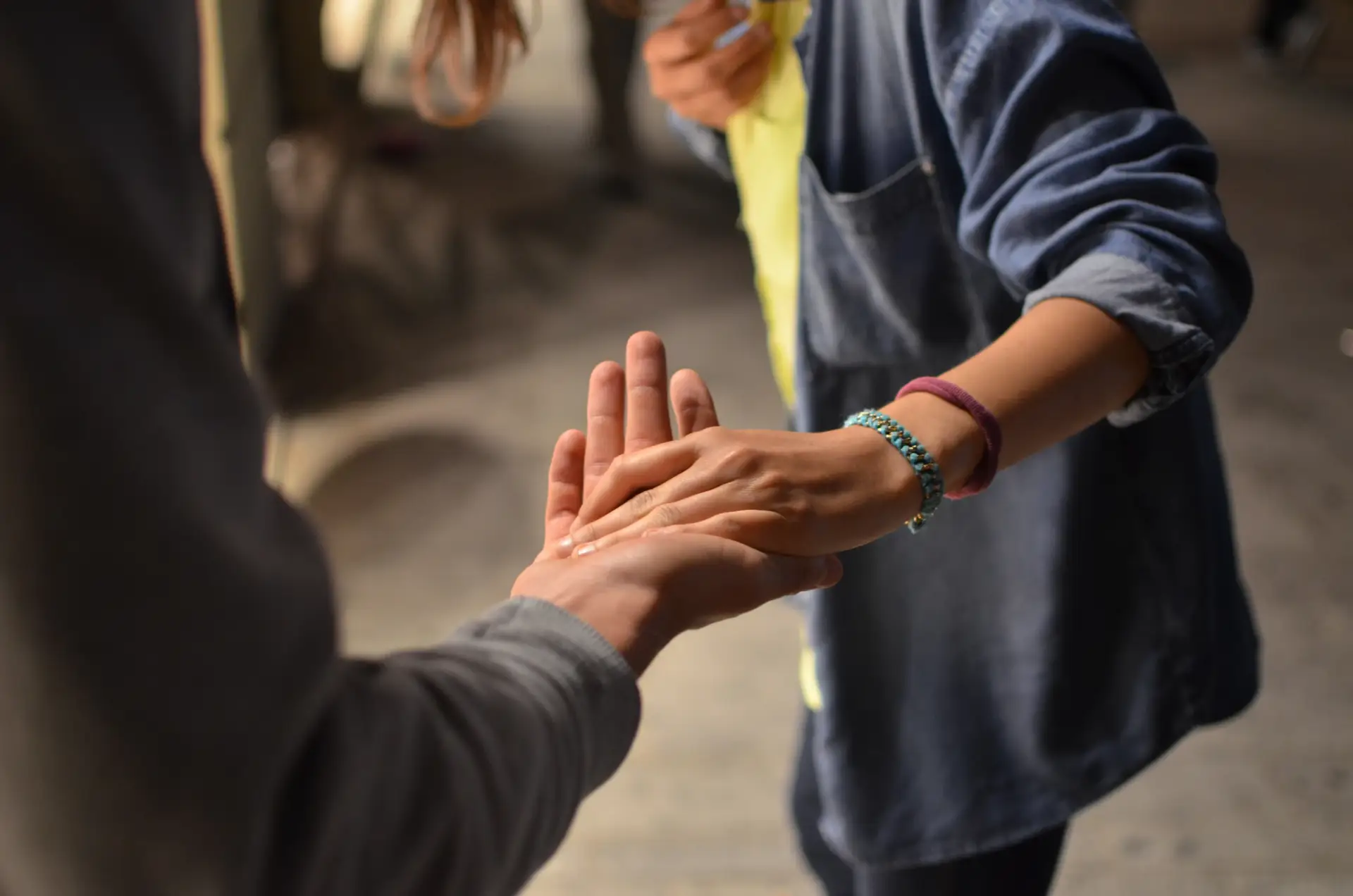 Hands reaching out to connect, symbolizing support and compassion in addiction treatment and harm reduction approaches.
