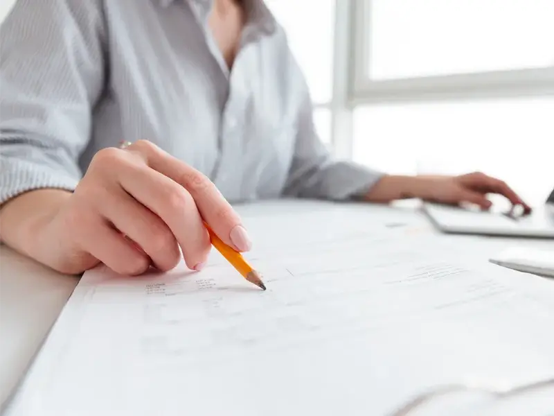 Person reviewing assessment documents with pencil, emphasizing the evaluation process for tailored treatment plans at SagePoint Behavioral Health in Elk Grove, CA.