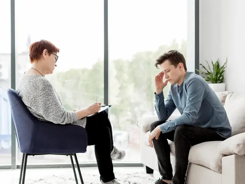 Therapist and client engaged in a counseling session, discussing emotional regulation and coping strategies in a supportive environment, emphasizing the principles of Dialectical Behavioral Therapy (DBT).