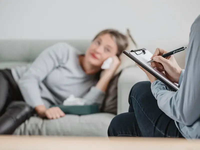 Therapist taking notes during a counseling session with a client, emphasizing mental health support and recovery strategies at SagePoint Behavioral Health.